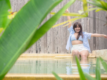 Portrait of young woman sitting on table