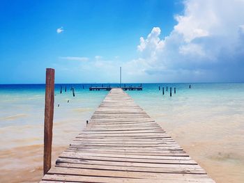 Pier over sea against sky