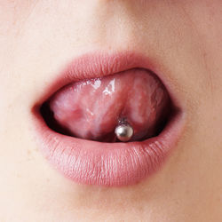 Close up of woman with pierced tongue