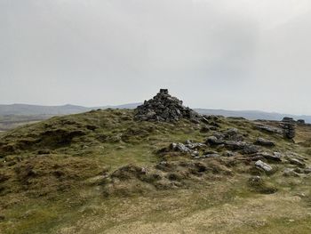 Scenic view of rocks on field against sky