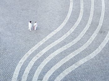 View of two elderly women talking on cobblestone square