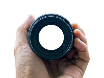 Close-up of hand holding camera over white background