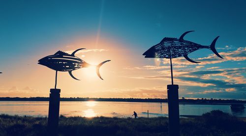 Silhouette bird flying over the sky