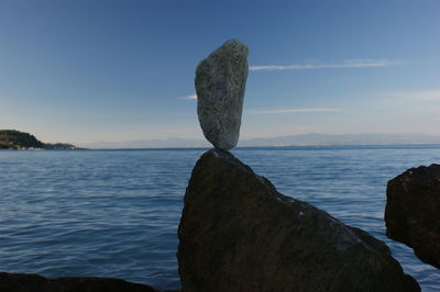 Scenic view of rocks on beach against sky