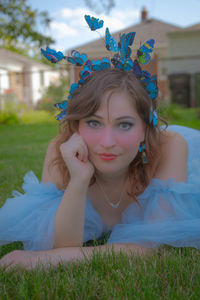 Portrait of young woman sitting on grass