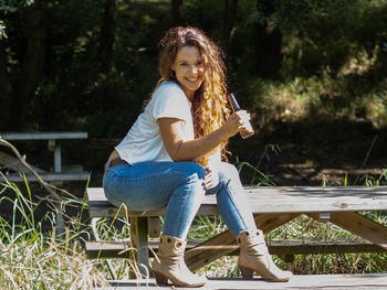 Portrait of smiling woman sitting on seat