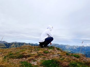 Full length of man standing on mountain against sky