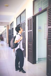 Side view of woman looking at entrance of building