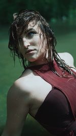 Close-up portrait of young woman in water