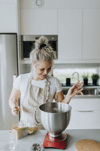 Smiling woman in kitchen