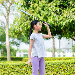 Full length of woman standing by plants