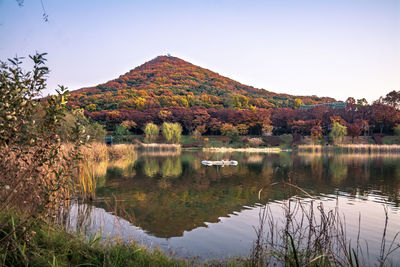 Scenic view of lake and mountains against clear sky