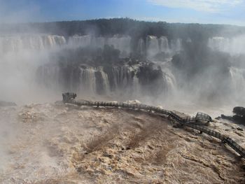 Scenic view of waterfall against sky