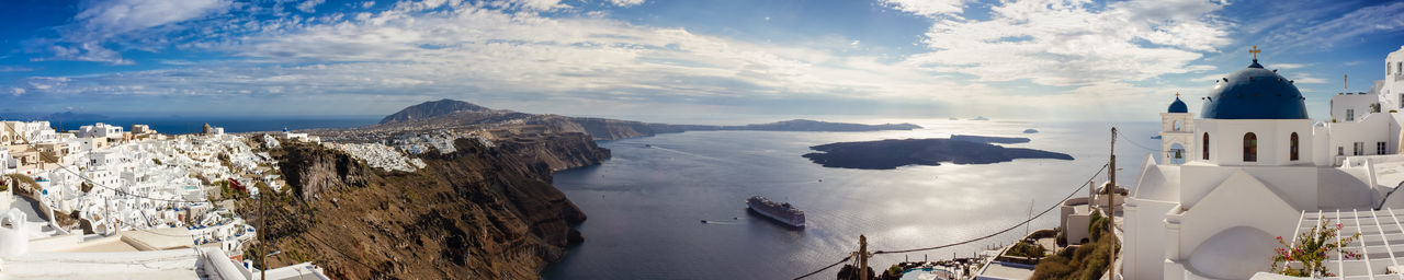 Panoramic view of sea and buildings against sky