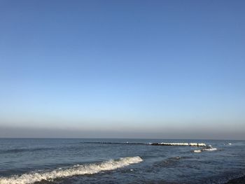 Scenic view of sea against clear blue sky