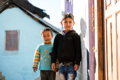 Portrait of father and son standing outdoors