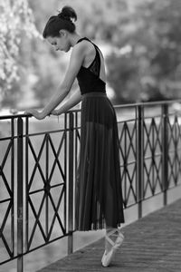 Woman standing on railing