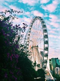 Ferris wheel against cloudy sky