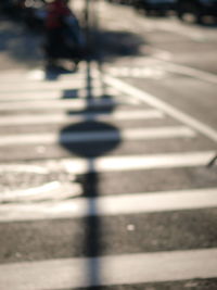 Close-up of shadow on road in city