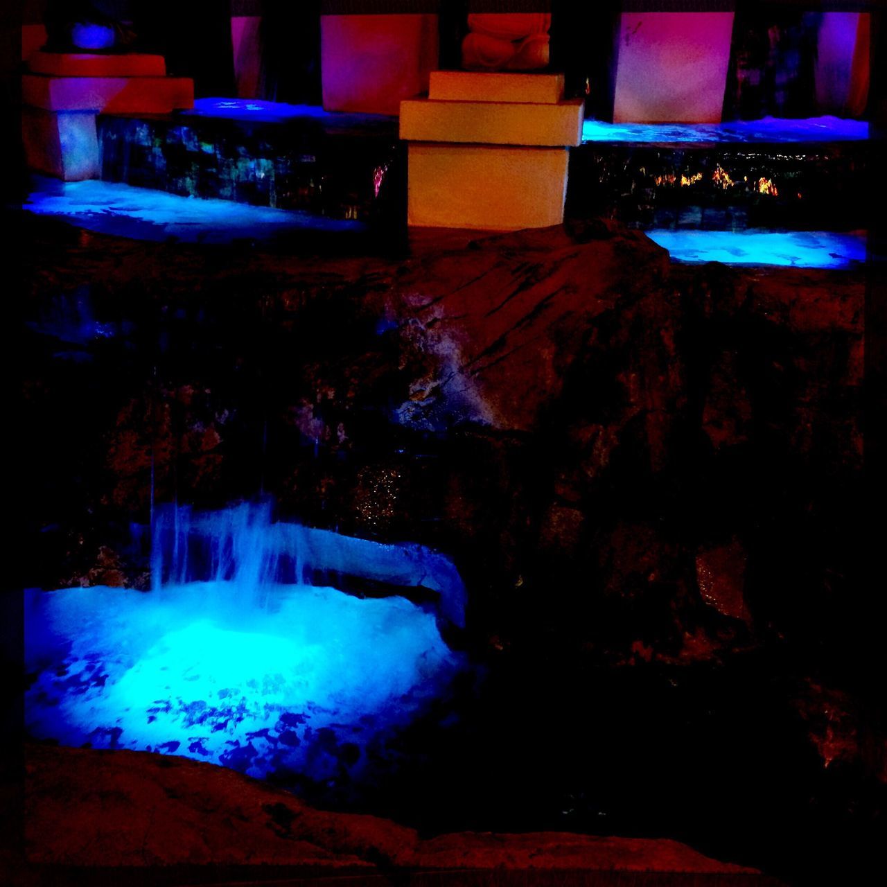 VIEW OF ILLUMINATED FOUNTAIN AT NIGHT