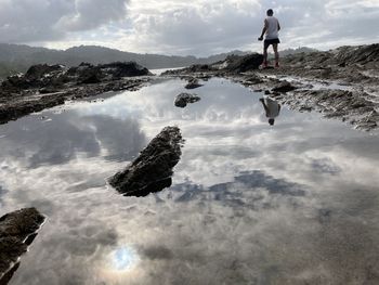 Rear view of man standing in water