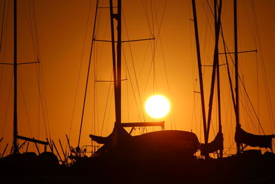 Silhouette boats against clear sky during sunset