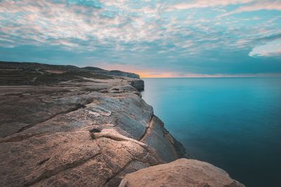 Scenic view of sea against sky at sunset