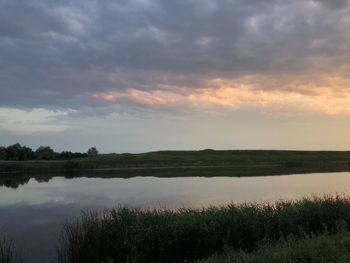 Scenic view of lake against sky during sunset