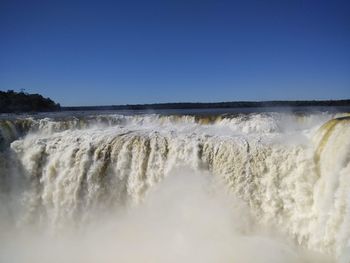 Scenic view of waterfall against clear sky