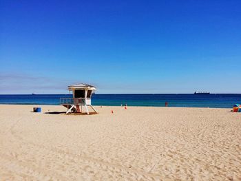 Scenic view of beach against blue sky