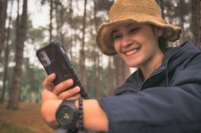 Young women checking social media in her smartphone with happy smiling