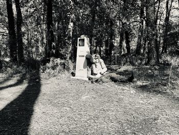 People on road amidst trees in forest