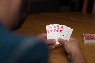 Midsection of man playing poker