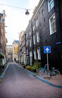 Street amidst buildings against sky in city