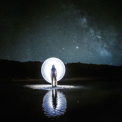 Digital composite image of man standing in lake against sky