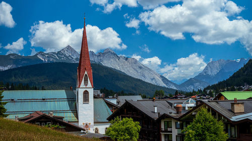 Panoramic view of buildings and mountains against sky