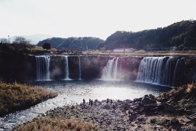 Scenic view of waterfall against sky