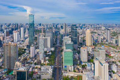 Aerial view of modern buildings in city against sky