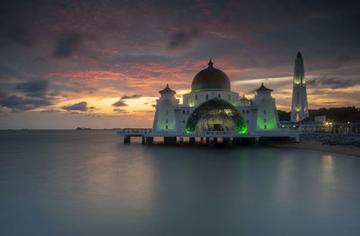 View of building against cloudy sky during sunset