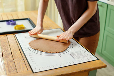 Midsection of man holding food on table