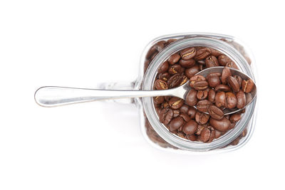 Close-up of ice cream in jar against white background