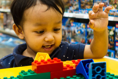 Portrait of cute boy with toy toys