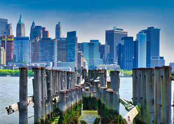 Panoramic view of bay and buildings against sky