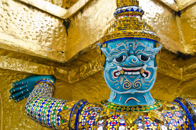 Low angle view of buddha statue against building