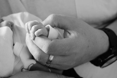 Midsection of couple holding hands