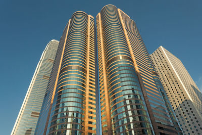 Low angle view of modern building against blue sky