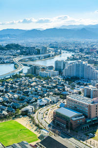 High angle view of buildings in city against sky