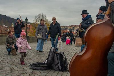 People at music concert against sky