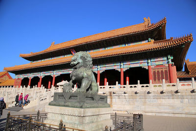 Exterior of temple against clear blue sky