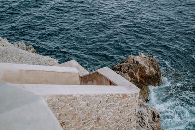 High angle view of rocks by sea